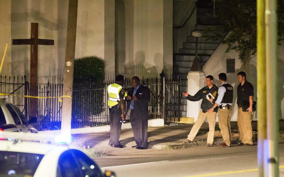 Police stand outside the Emanuel AME Church following the shooting (AP Photo/David Goldman)