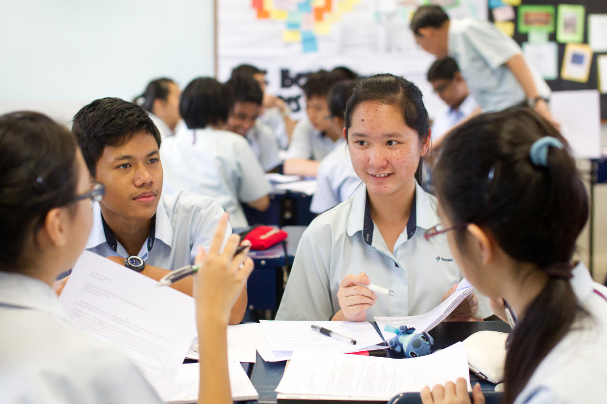 Singapore's Riverside Secondary School Secondary 4 students are seen during an English Class group discussion period on Thursday July 5, 2012. (AP Photo/Ray Chua)