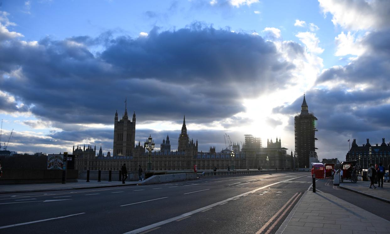 The sun starts to set behind the Houses of Parliament (AP)