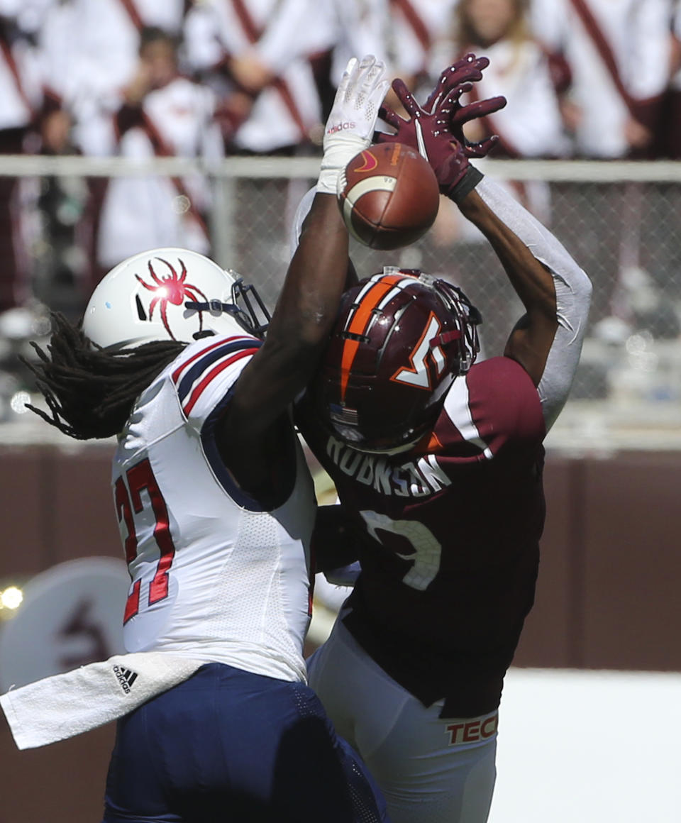 Virginia Tech wide receiver Tayvion Robinson (9) has a pass reception broken up by Richmond's Nile Harris (27) in the first half of the Richmond Virginia Tech NCAA college football game in Blacksburg, Va., Saturday, Sept. 25 2021. (Matt Gentry/The Roanoke Times via AP)