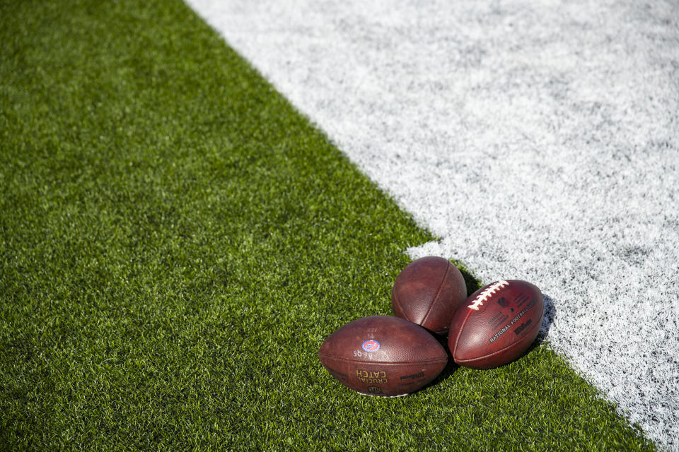 Generic footballs sit on the field.