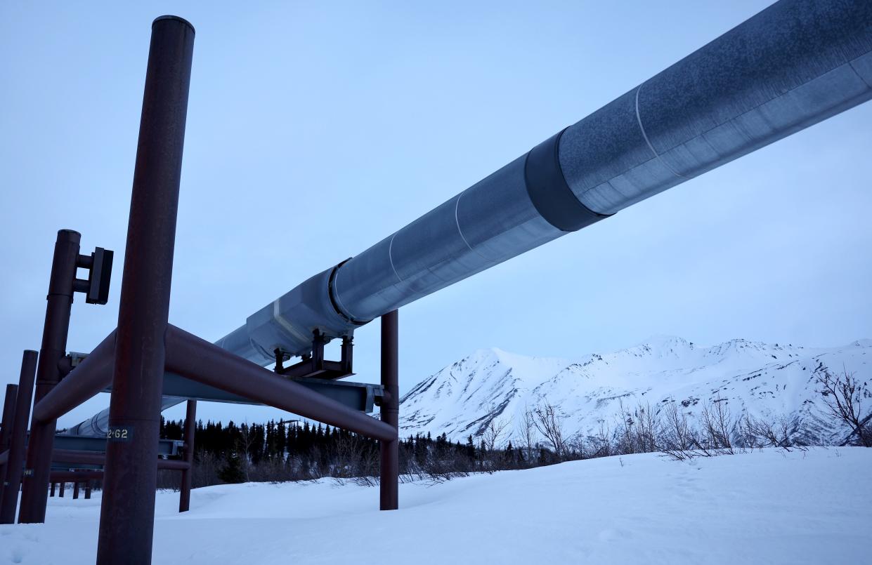 A part of the Trans Alaska Pipeline System runs past Alaska Range mountains on May 5, 2023 near Delta Junction, Alaska.