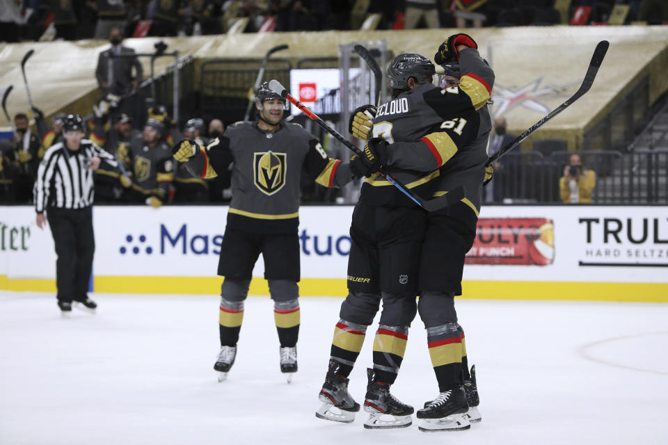 Vegas Golden Knights defenseman Zach Whitecloud (2) celebrates with right wing Mark Stone (61) after Whitecloud scored a goal against the Minnesota Wild during the second period of Game 7 of an NHL hockey Stanley Cup first-round playoff series Friday, May 28, 2021, in Las Vegas. (AP Photo/Joe Buglewicz)