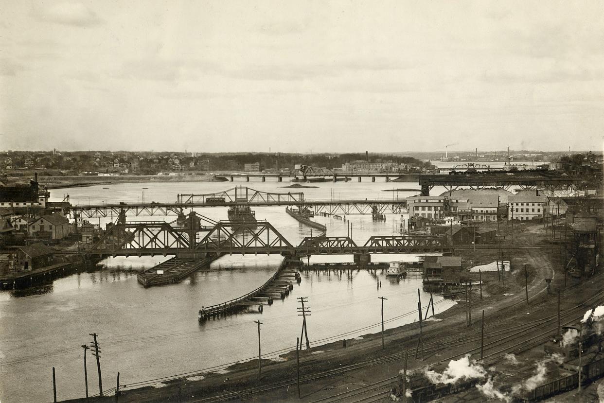 A 1921 view of the Seekonk River with its moveable bridges, looking north from East Providence toward Pawtucket in the distance. The steel-truss swing bridge at center was later replaced by the 1930 Washington Bridge, a bascule drawbridge.