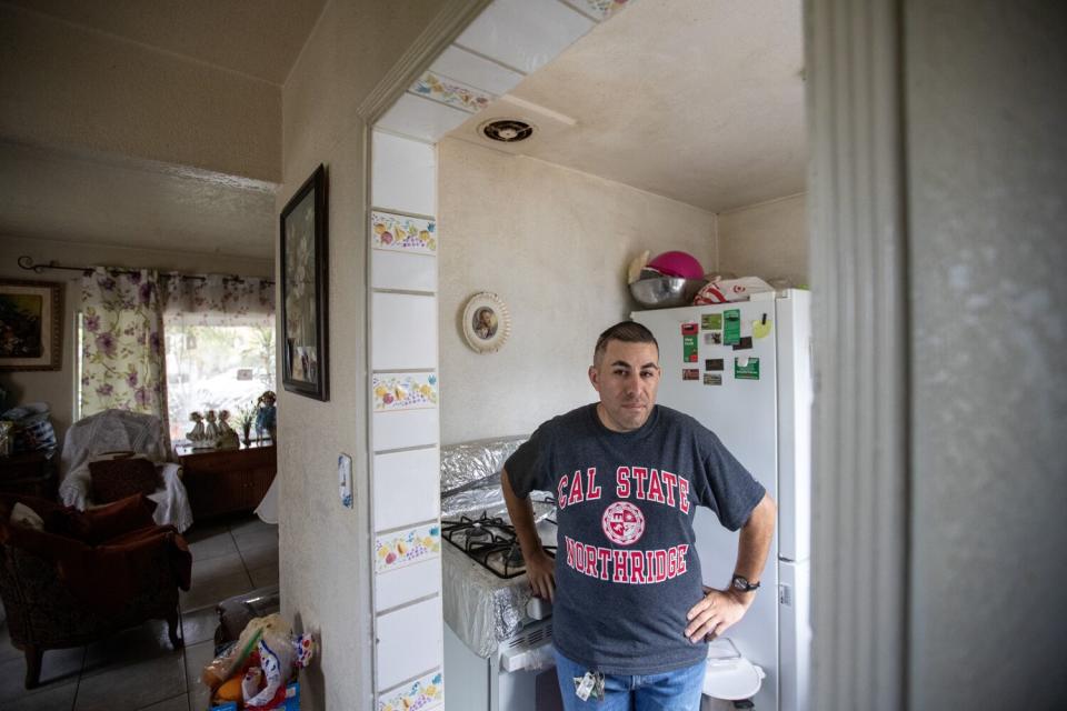 A man stands in his kitchen.