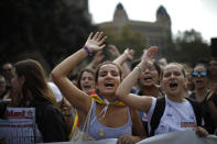 People, some wearing yellow ribbons in support of jailed pro-independence politicians, protest in Barcelona, Spain, Monday, Oct. 14, 2019. Spain's Supreme Court on Monday convicted 12 former Catalan politicians and activists for their roles in a secession bid in 2017, a ruling that immediately inflamed independence supporters in the wealthy northeastern region. Poster reads in Catalan, General Strike. (AP Photo/Emilio Morenatti)