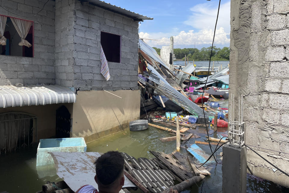 Household belongings float in water after an earthquake shook Machala, Ecuador, Saturday, March 18, 2023. The U.S. Geological Survey reported an earthquake with a magnitude of about 6.8 that was centered just off the Pacific Coast, about 50 miles (80 kilometers) south of Guayaquil. (AP Photo/Erick Feijoo)