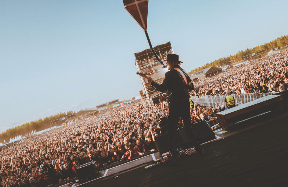 John 5 performs onstage in front of a festival audience