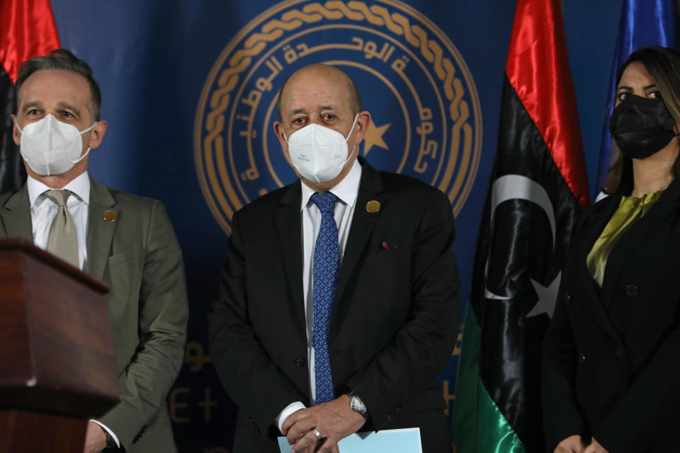 The foreign ministers of Germany, France and Libya, from Left to right, German Foreign Minister Heiko Maas, French Foreign Affairs Minister Jean-Yves Le Drian, and Libyan Foreign Minister, Najla el-Mangoush, take the stage, in Tripoli, Libya, Thursday, March 25, 2021. The foreign ministers of France, Italy and Germany arrived Thursday in Tripoli to show their support to Libya's newly elected transitional authorities, who are expected to lead the war-stricken country through general elections end of 2021. (AP Photo/Hazem Ahmed)