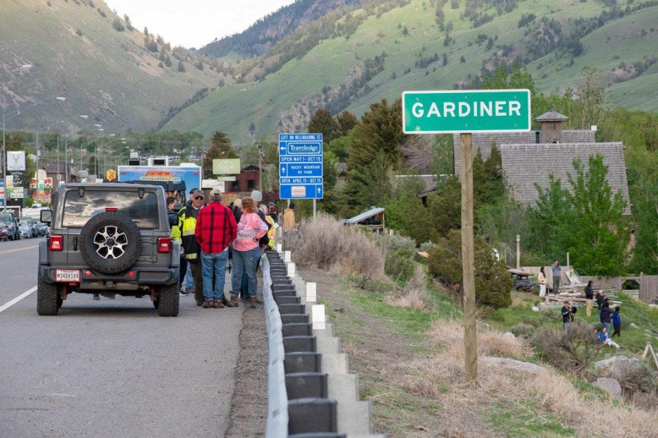 People gather near Gardiner, Montana, as mudslides and flooding in Yellowstone continue to force local communities left without clean water or power to evacuate.