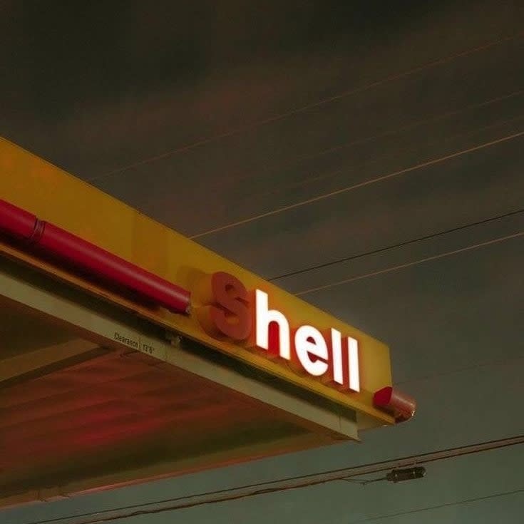 Signage of a Shell gas station with the S burnt out