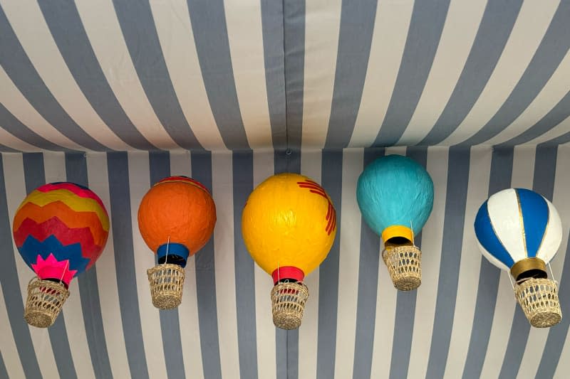 Papier-mâché balloons hanging from homemade tent.