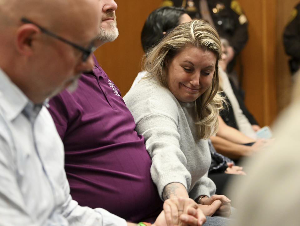 Nicole Beausoleil, mother of Oxford shooting victim Madisyn Baldwin, right, reaches over to grab the hand of Craig Shilling, father of shooting victim Justin Shilling, following the guilty verdict of James Crumbley, in Oakland County Court in Pontiac, Mich., Thursday, March 14, 2024. Crumbley, the father of the Michigan school shooter, was found guilty of involuntary manslaughter, a second conviction against the teen’s parents who were accused of failing to secure a gun at home and doing nothing to address acute signs of his mental turmoil. (Robin Buckson/Detroit News via AP, Pool)