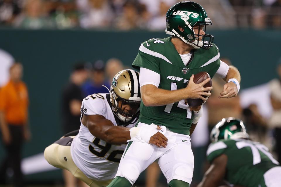 New York Jets quarterback Sam Darnold (14) breaks away from New Orleans Saints' Marcus Davenport (92) during the first half of a preseason NFL football game Saturday, Aug. 24, 2019, in East Rutherford, N.J. (AP Photo/Noah K. Murray)
