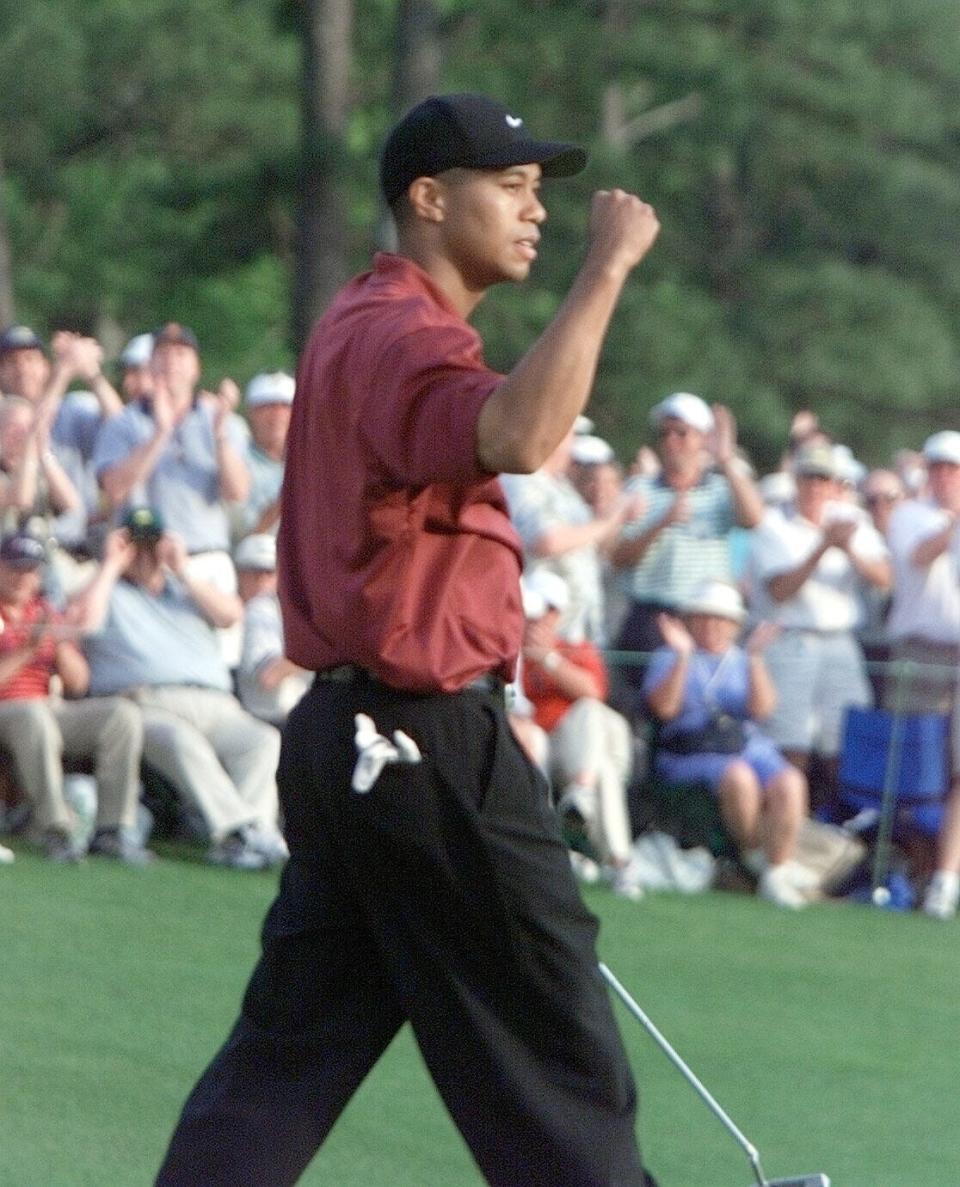 The crowds at the 18th green cheer as Tiger Woods celebrates his second Masters Championship after he sunk a putt for a birdie, in round 4 of the Masters Tournament Sunday at the Augusta National Golf Club on April 8, 2001.