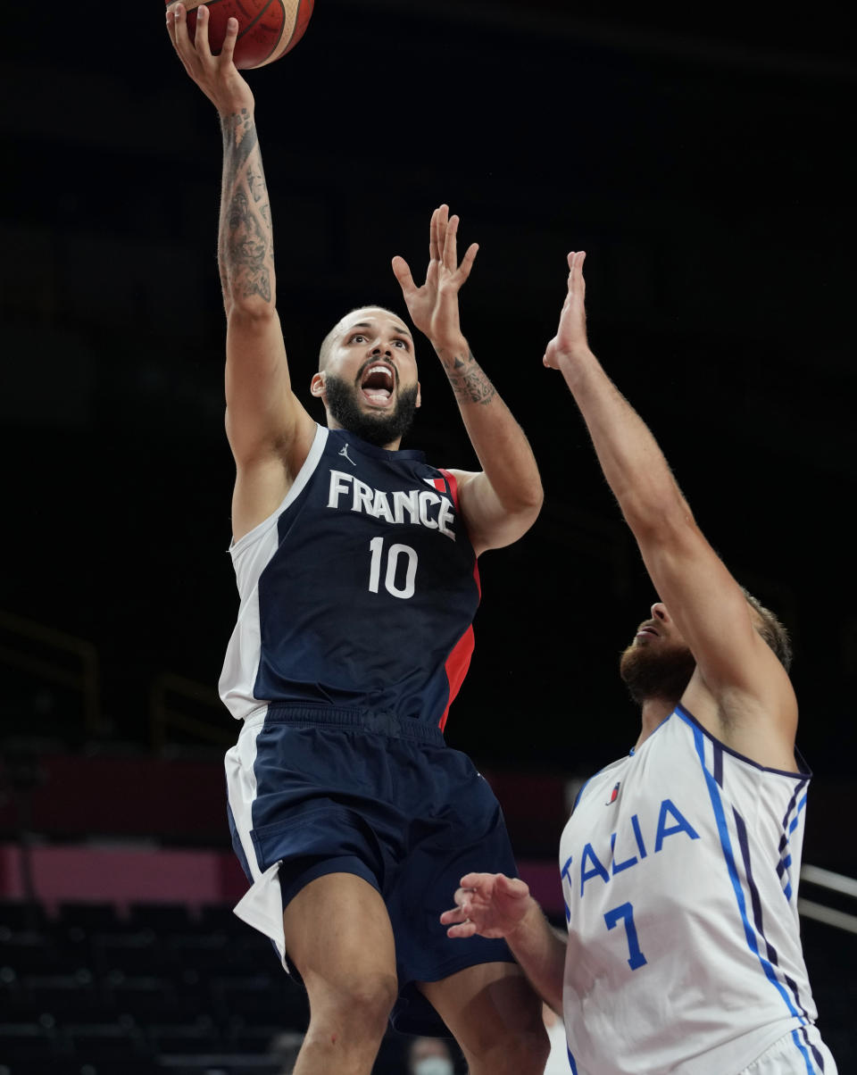 France's Evan Fournier (10) scores over Italy's Stefano Tonut (7) during a men's basketball quarterfinal round game at the 2020 Summer Olympics, Tuesday, Aug. 3, 2021, in Saitama, Japan. (AP Photo/Eric Gay)