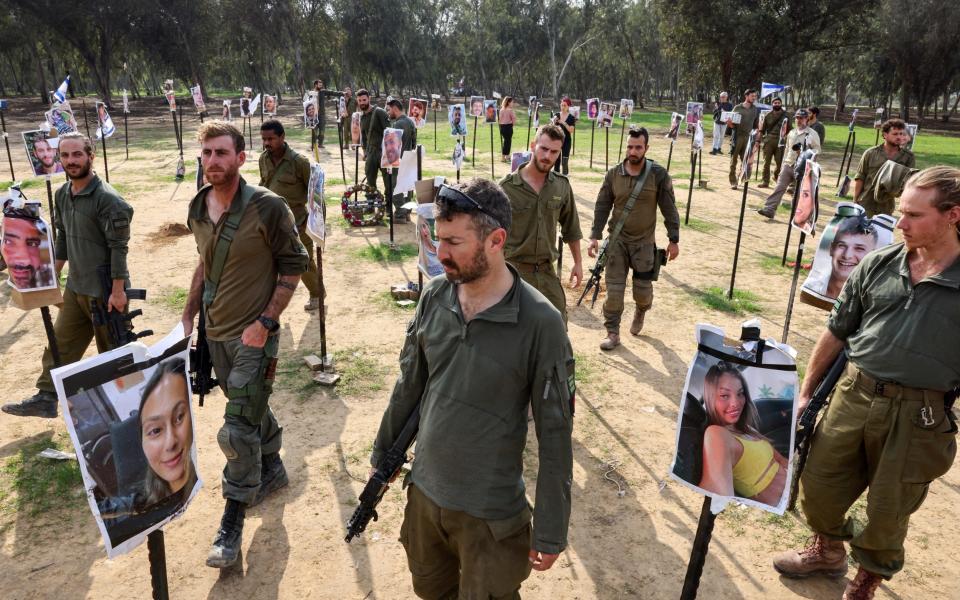 Israeli soldiers gather at the abandoned site of the Supernova music festival