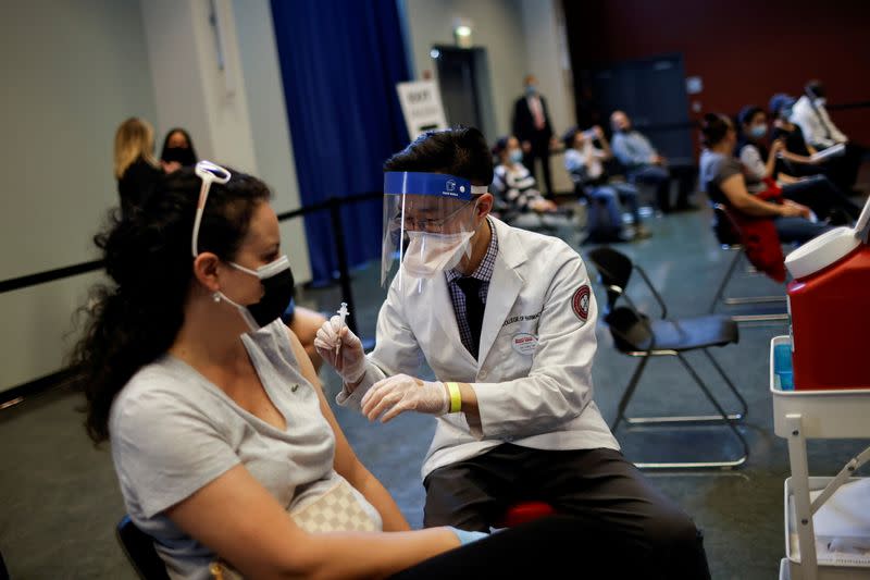 FILE PHOTO: A woman receives a dose of the Johnson & Johnson coronavirus disease (COVID-19) vaccine during a visit of U.S. Vice President Kamala Harris to a vaccination center in Chinatown, in Chicago