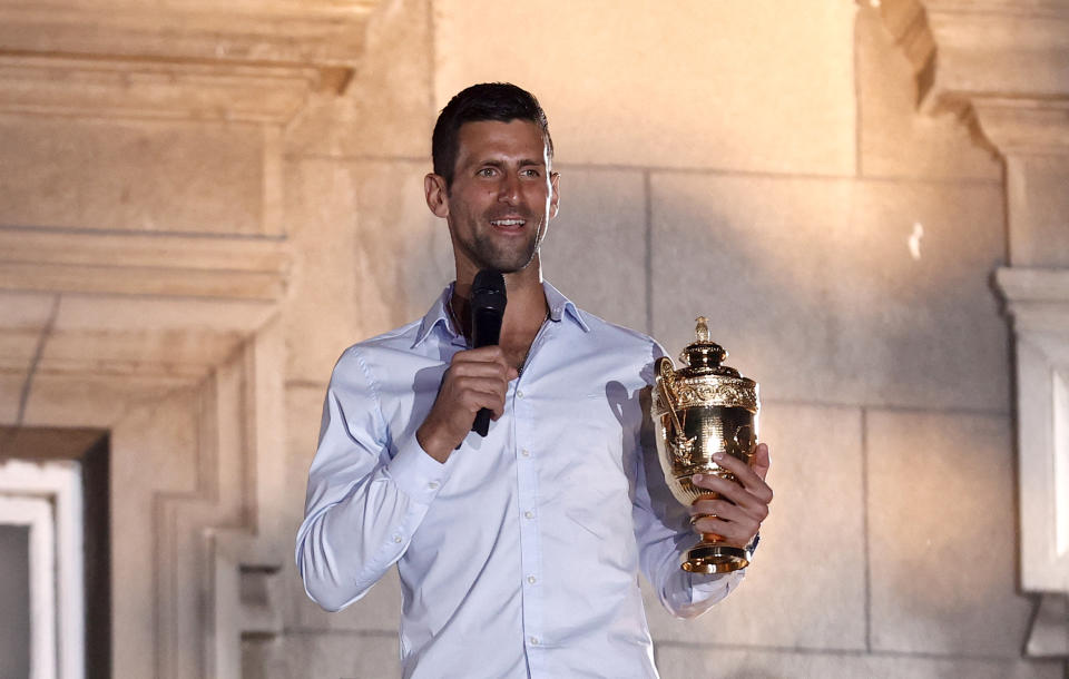 Novak Djokovic, pictured here celebrating with his replica Wimbledon trophy in Serbia.