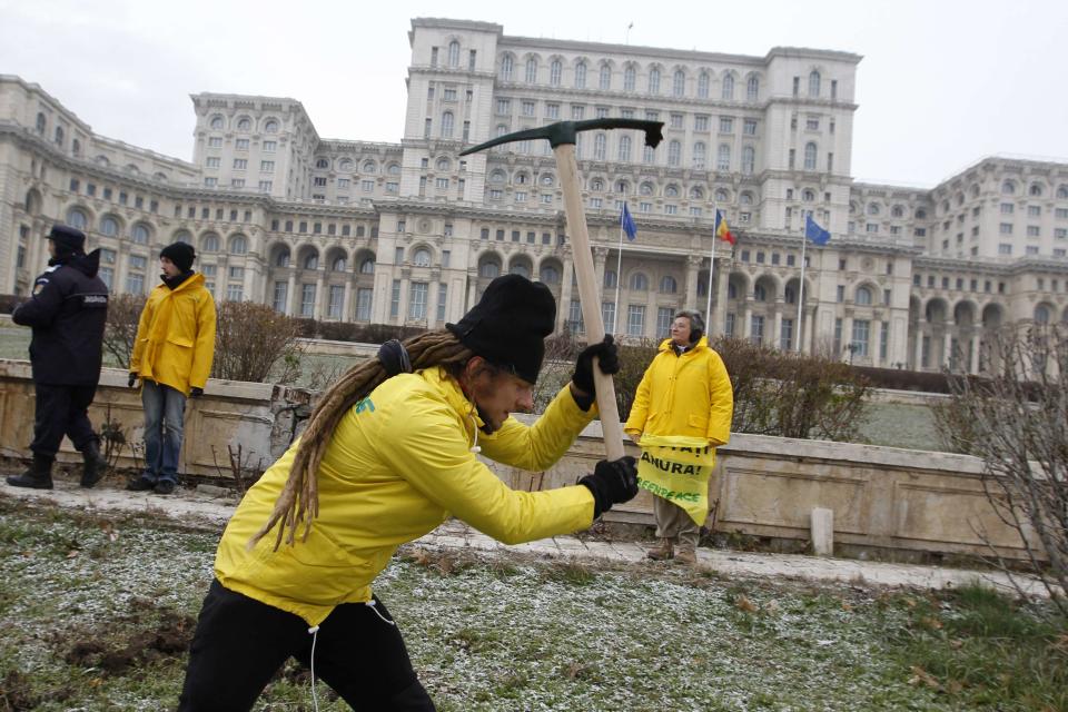 Greenpeace activists dig into the yard of Romania's Parliament in Bucharest