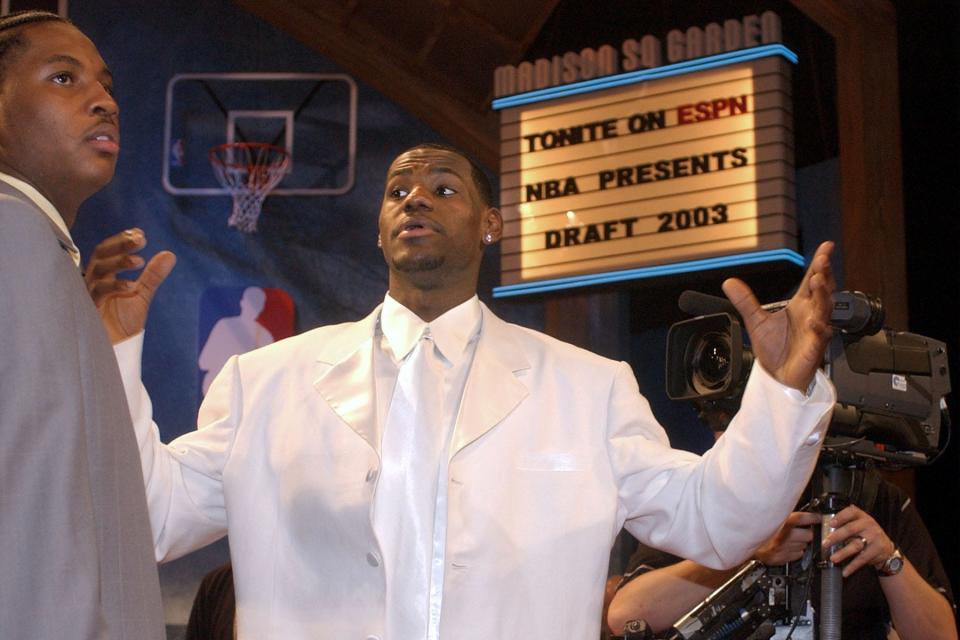 LeBron James goes in for a hug with Carmelo Anthony during the NBA Draft on June 26, 2003, in New York.