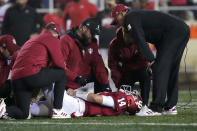 Indiana quarterback Jack Tuttle (14) lies on the ground after being tackled while playing Ohio State during the first quarter of an NCAA college football game in Bloomington, Ind., Saturday, Oct. 23, 2021. (AP Photo/AJ Mast)