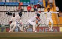Cricket - India v England - Third Test cricket match - Punjab Cricket Association Stadium, Mohali, India - 28/11/16. England's Alastair Cook (2-R) is bowled. REUTERS/Adnan Abidi