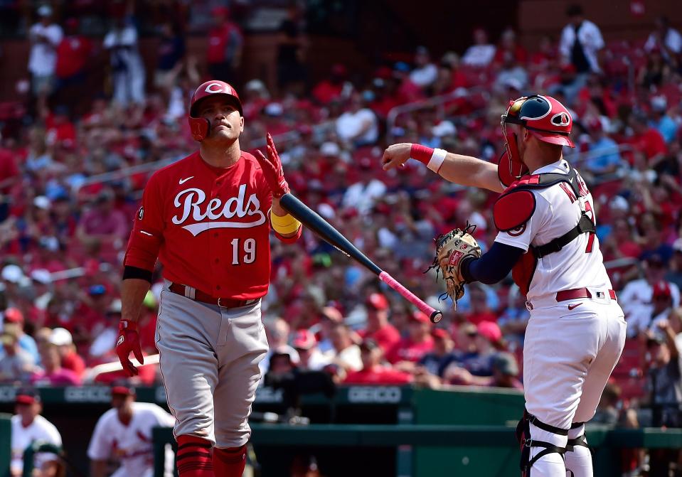 Joey Votto tosses his bat after striking out during a game against the Cardinals.