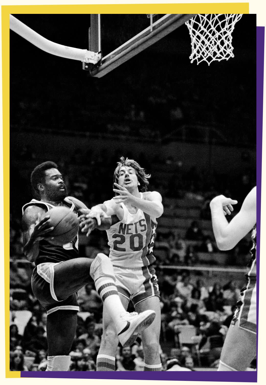 Black-and-white photo of Lucius Allen on left jumping and holding onto a ball under a basket with an opponent to his left.