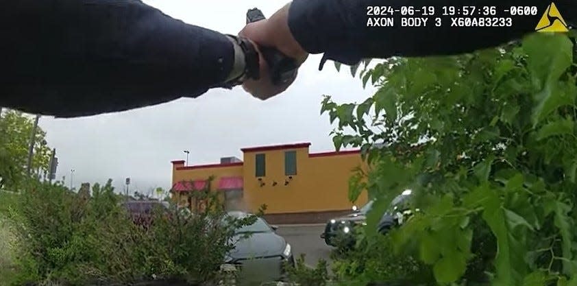 This still frame of body camera footage taken from a Pueblo police officer shows the officer shooting at a vehicle occupied by Ronald Ray Valdez on June 19. Valdez was killed in the shooting, which is being investigated.