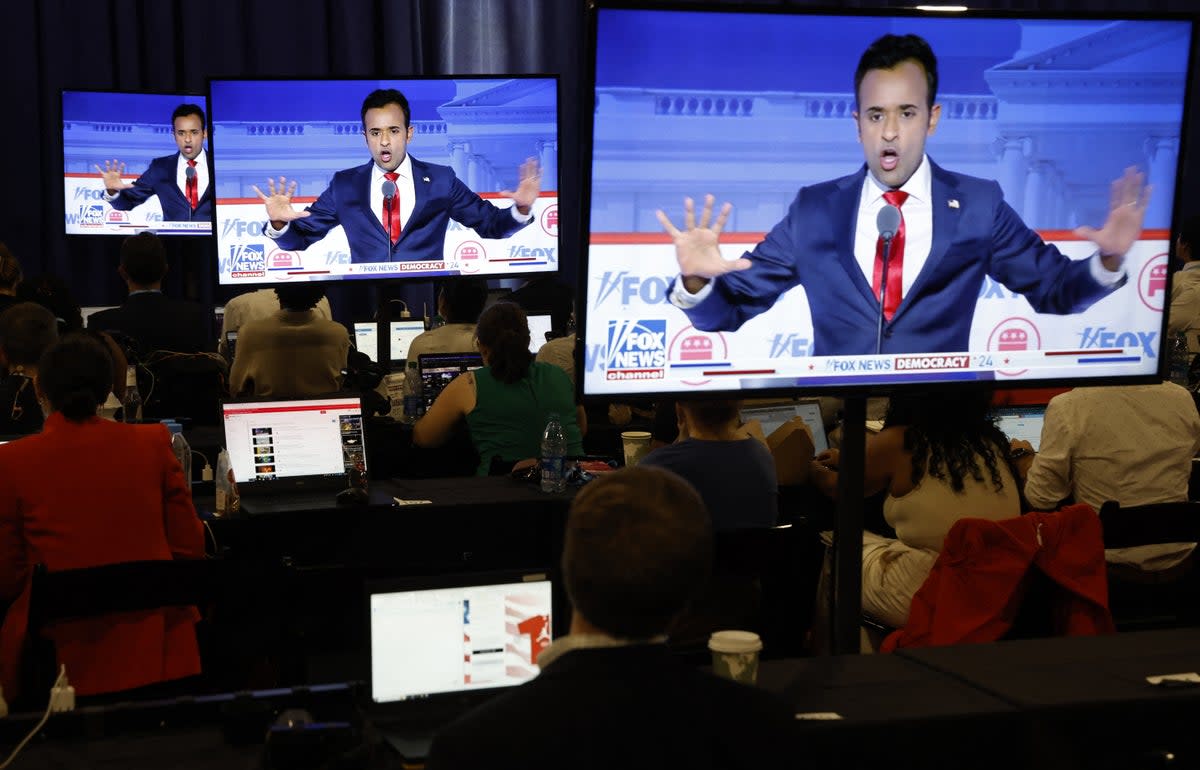 Former biotech executive Vivek Ramaswamy is seen debating on screens in the media filing center at the first Republican candidates' debate of the 2024 U.S. presidential campaign in Milwaukee, Wisconsin (REUTERS)