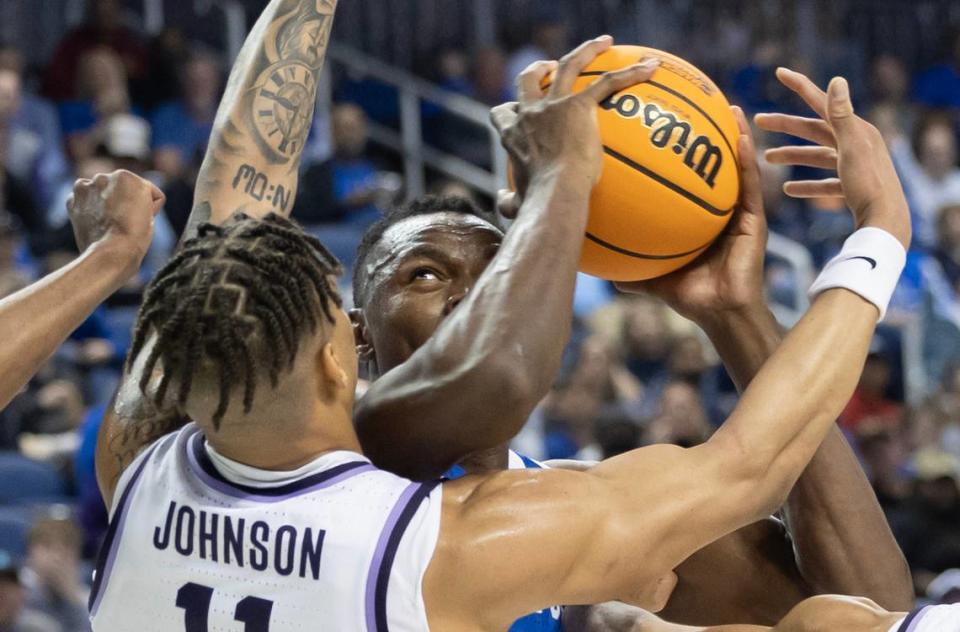 Kansas State’s Keyontae Johnsons defends Kentucky’s Oscar Tshiebwe during the first half of their second round NCAA Tournament game in Greensboro, NC on Sunday.