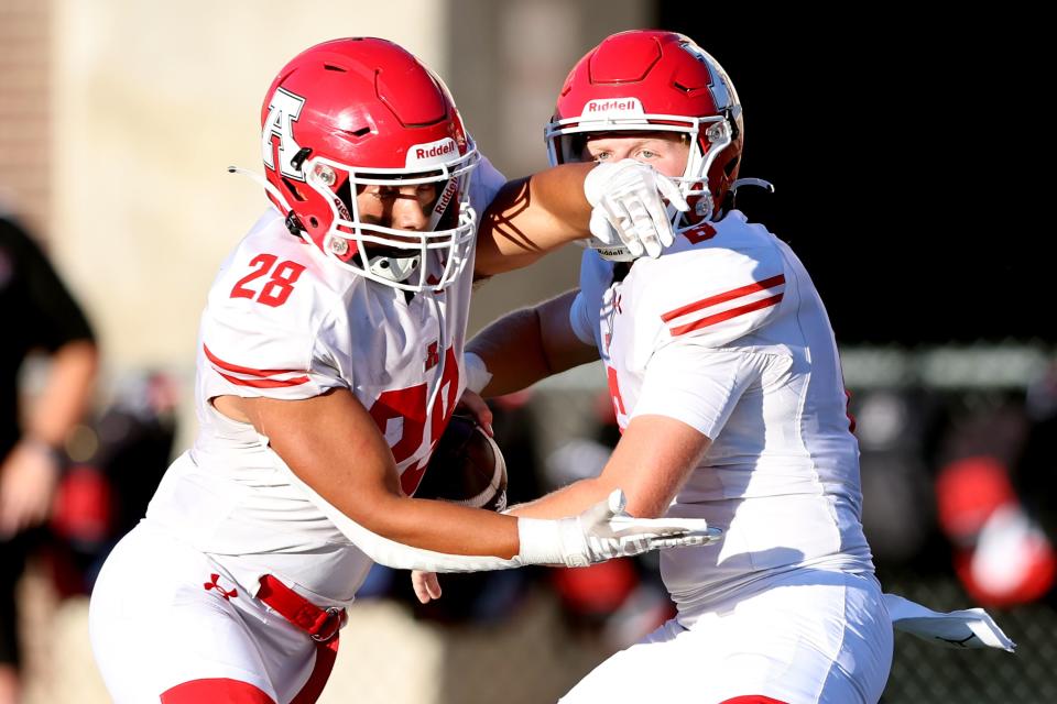 American Fork’s quarterback Dylan Story fakes a handoff to running back Jacob Eardley as West and American Fork play in Salt Lake City on Friday, Aug. 25, 2023. AF won 45-21. | Scott G Winterton, Deseret News