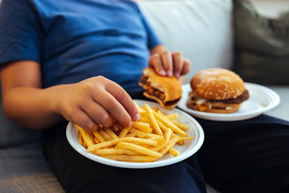 Child eating burger and fries