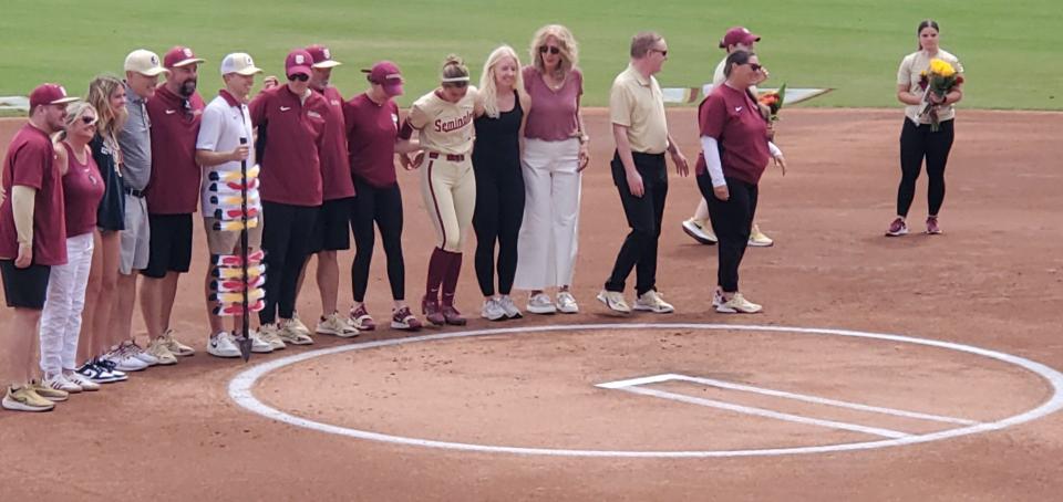 Sydney Sherrill takes a group photo with the FSU softball seniors and their relatives on Sunday, April 28. Sherill came to support her best friend and teammate, Devin Flaherty, during Senior Day at Joanne Graff Field.