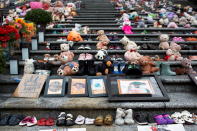 Teddy bears, shoes, artwork and flowers left in memory of the Kamloops residential school victims remain on the steps of the former Vancouver Art Gallery North Plaza, on Canada's first National Day for Truth and Reconciliation, honouring the lost children and survivors of Indigenous residential schools, their families and communities, in Vancouver, British Columbia, Canada September 30, 2021. REUTERS/Amy Romer