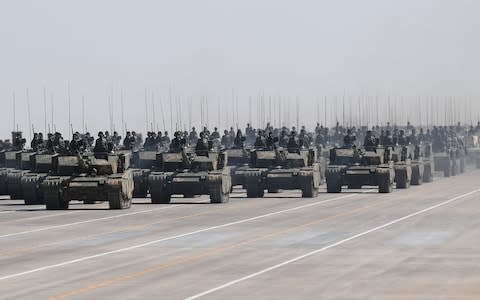 Chinese Type 99A tanks take part in a military parade at the Zhurihe training base in China's northern Inner Mongolia region on July 30, 2017 - Credit: AFP
