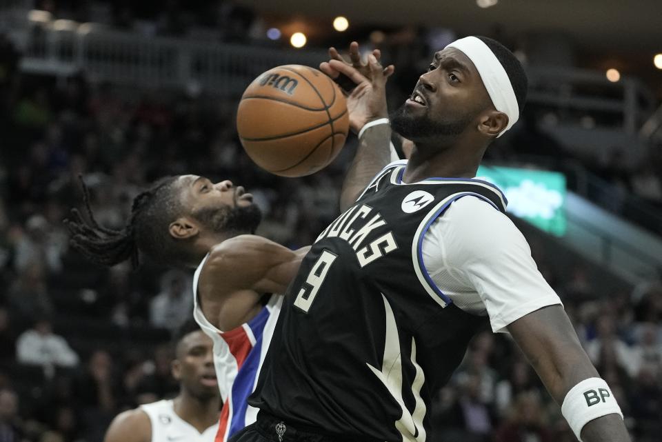 Milwaukee Bucks' Bobby Portis and Detroit Pistons' Nerlens Noel go after a loose ball during the second half of an NBA basketball game Monday, Oct. 31, 2022, in Milwaukee. The Bucks won 110-108. (AP Photo/Morry Gash)