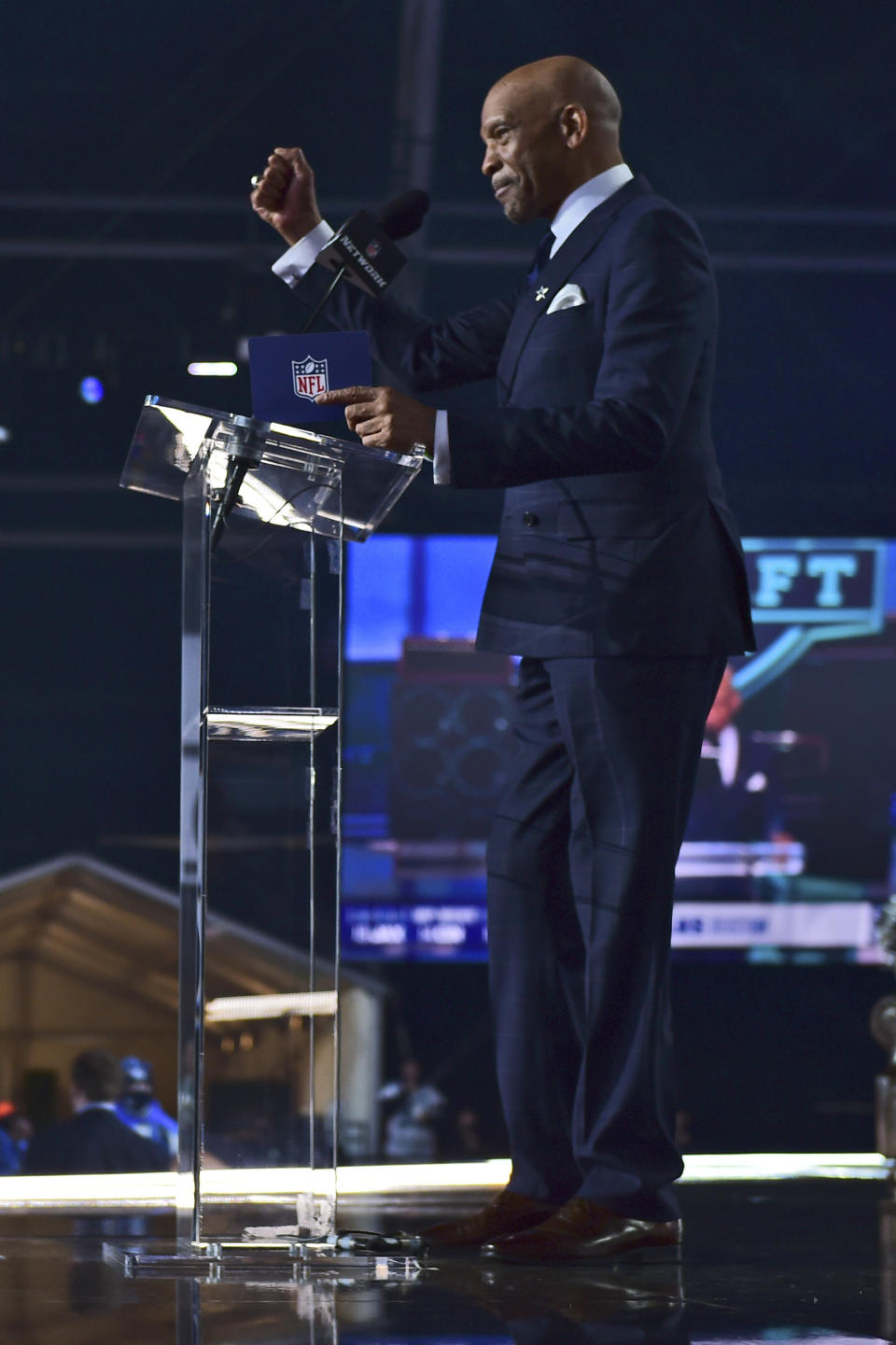 Former Dallas Cowboys player Drew Pearson announces Kentucky cornerback Kelvin Joseph as the team's pick during the second round of the NFL football draft Friday, April 30, 2021, in Cleveland. (AP Photo/David Dermer)