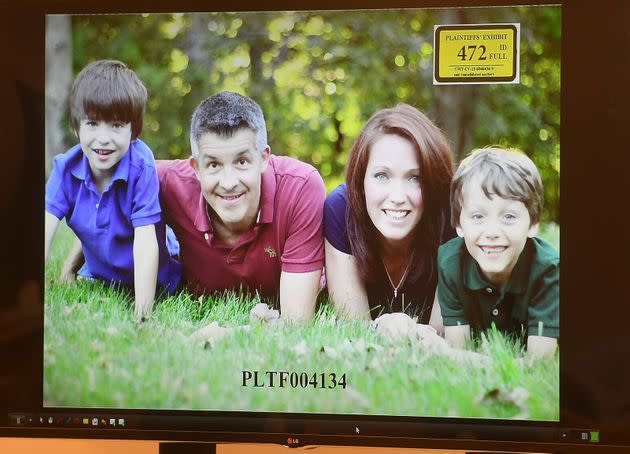 A photo of Ian and Nicole Hockley, and their sons Dylan (left) and Jake, is displayed for the jury panel during the Hockley's testimony in the Alex Jones defamation trial at Superior Court in Waterbury, Connecticut, on Tuesday. (Photo: Brian A. Pounds/Hearst Connecticut Media via Associated Press)