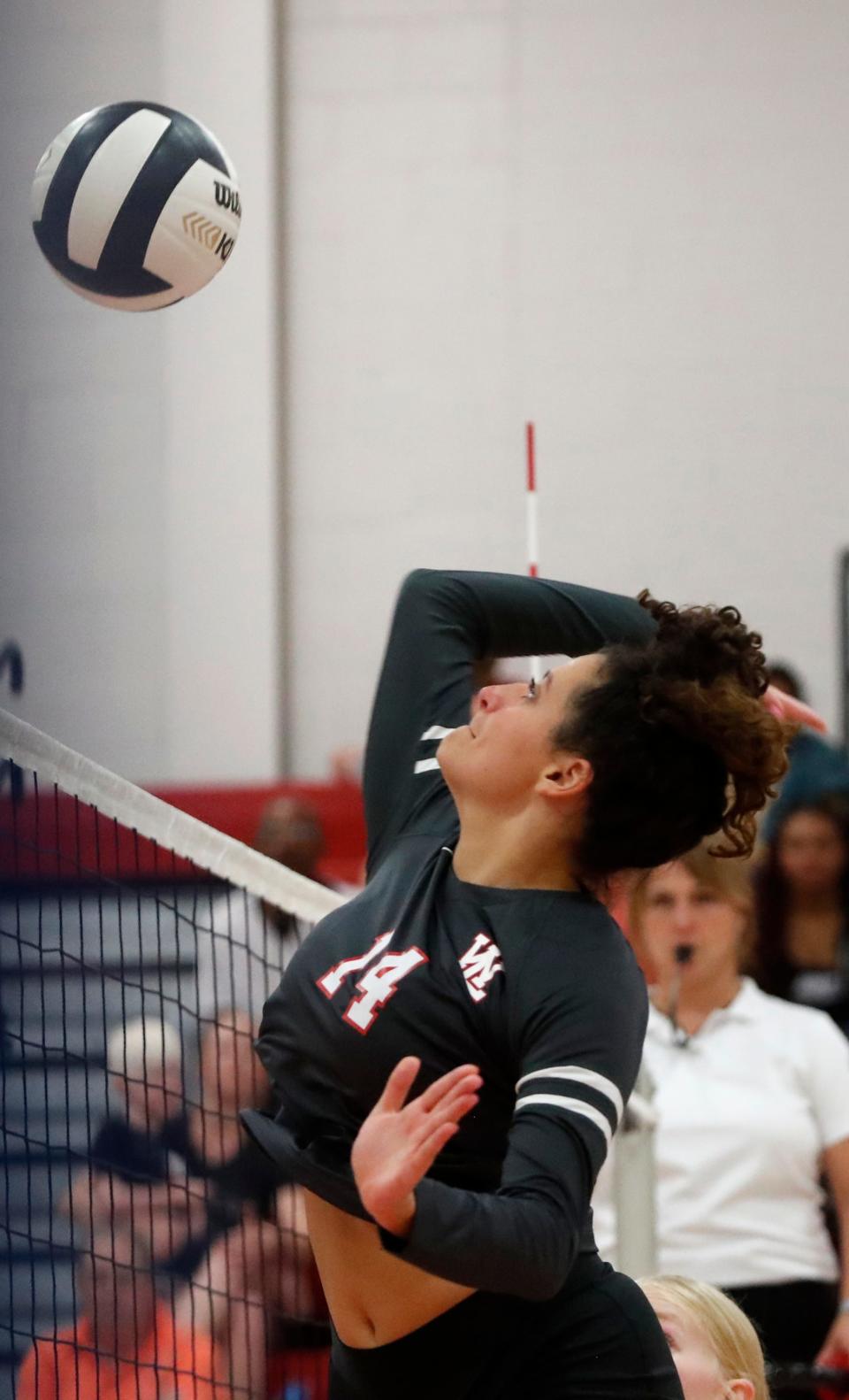 West Lafayette Red Devils middle hitter Annie Karlaftis (14) spikes the ball during the IHSAA volleyball match against the Lafayette Jeff Bronchos, Tuesday, Aug. 23, 2022, at West Lafayette High School in West Lafayette, Ind. 
