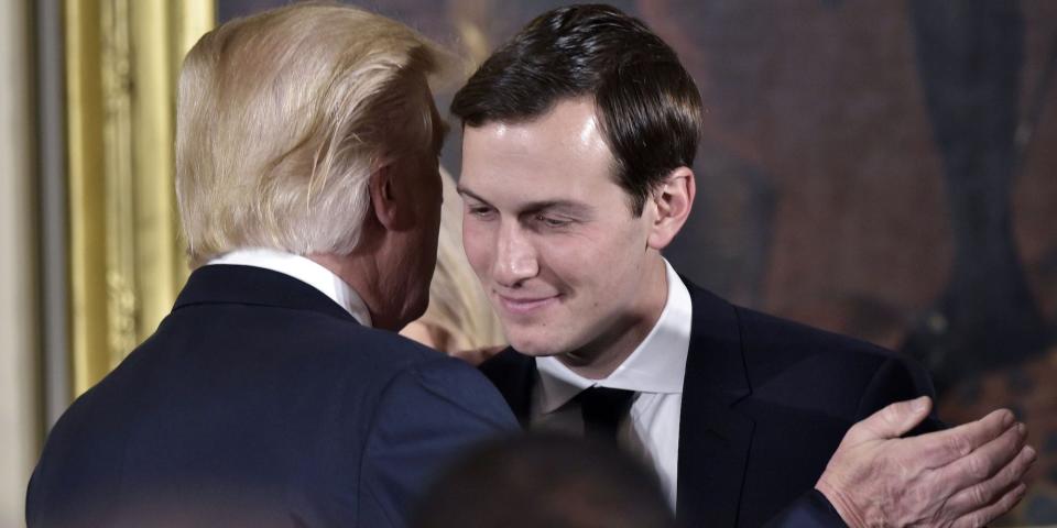 US President Donald Trump (L) congratulates his son-in-law and senior advisor Jared Kushner