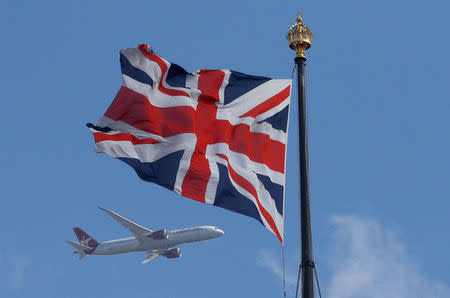 FILE PHOTO A Virgin Atlantic passenger jet flies past a Union Flag in central London, Britain June 24, 2016. REUTERS/Phil Noble/File photo