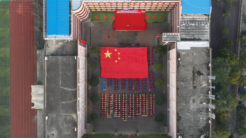 SHIYAN, CHINA - DECEMBER 10, 2020 - A giant five-starred red flag moves past an educational activity attended by more than 1,300 teachers and students in Shiyan city, Hubei province, China, On December 10, 2020.- PHOTOGRAPH BY Costfoto / Barcroft Studios / Future Publishing (Photo credit should read Costfoto/Barcroft Media via Getty Images)