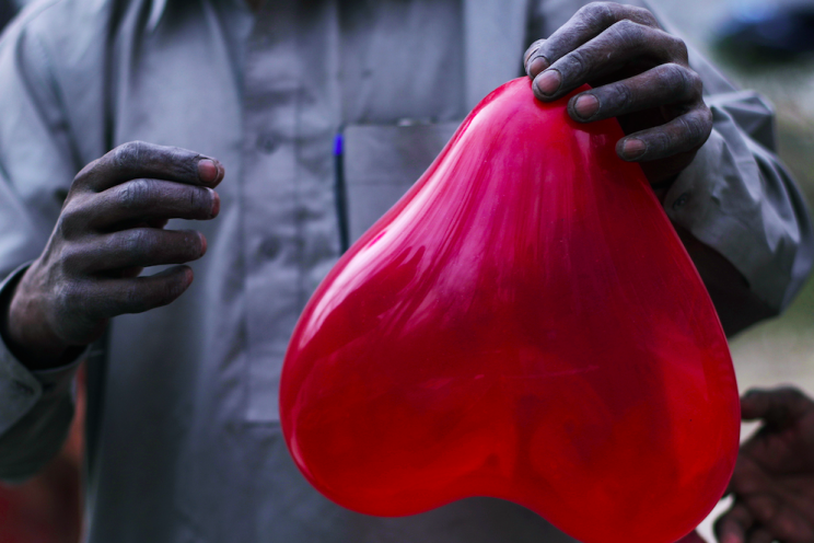 A vendor in Islamabad with a red balloon for Valentine's Day (Picture: Rex)