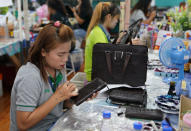 <p>A worker polishes a wallet made from crocodile skin at Sri Ayuthaya Crocodile farm in Ayutthaya province, Thailand, May 23, 2017. (Photo: Athit Perawongmetha/Reuters) </p>