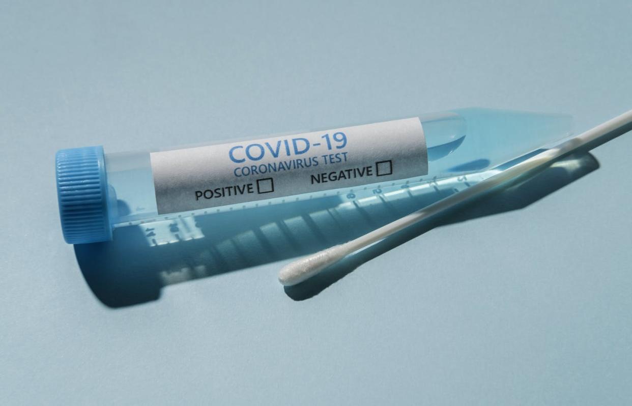 <span class="caption">Pooling samples means one test can screen multiple people.</span> <span class="attribution"><a class="link " href="https://www.gettyimages.com/detail/photo/covid-19-test-vial-and-swab-on-blue-background-royalty-free-image/1222962718?adppopup=true" rel="nofollow noopener" target="_blank" data-ylk="slk:Tetra Images via Getty Images;elm:context_link;itc:0;sec:content-canvas"> Tetra Images via Getty Images</a></span>