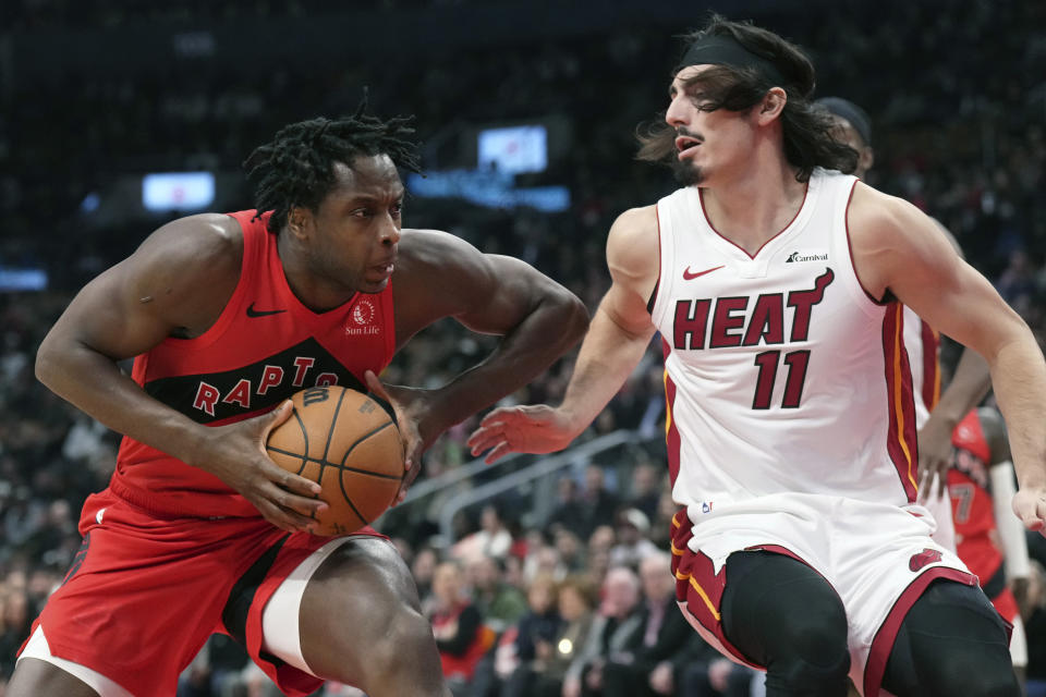 Toronto Raptors' O.G. Anunoby, left, drives at Miami Heat's Jaime Jaquez Jr. during the first half of an NBA basketball game, Wednesday, Dec. 6, 2023 in Toronto. (Chris Young/The Canadian Press via AP)