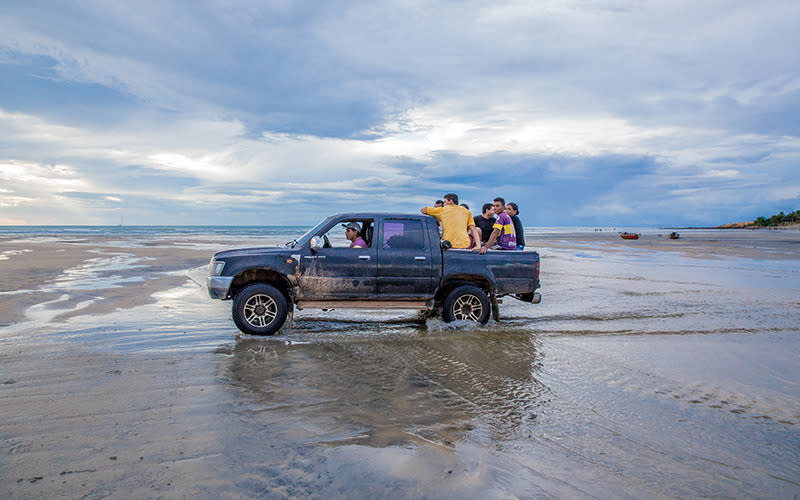 Locals negotiate the sand dunes in a 4x4 pick-up truck – the only way to get around when there are no roads.