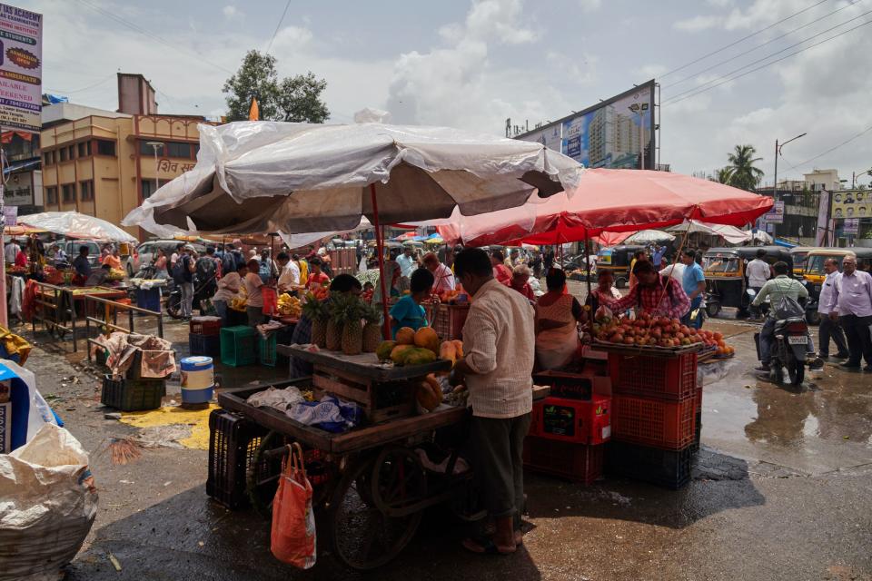 Street vendors under their umbrellas at local market.